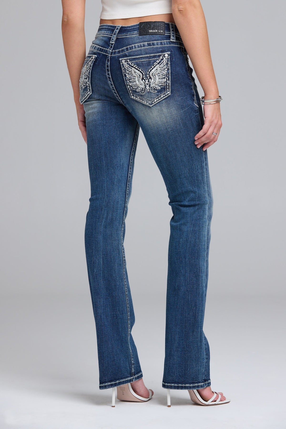 Product view 1 of blue bootcut jeans with wing embroidery
