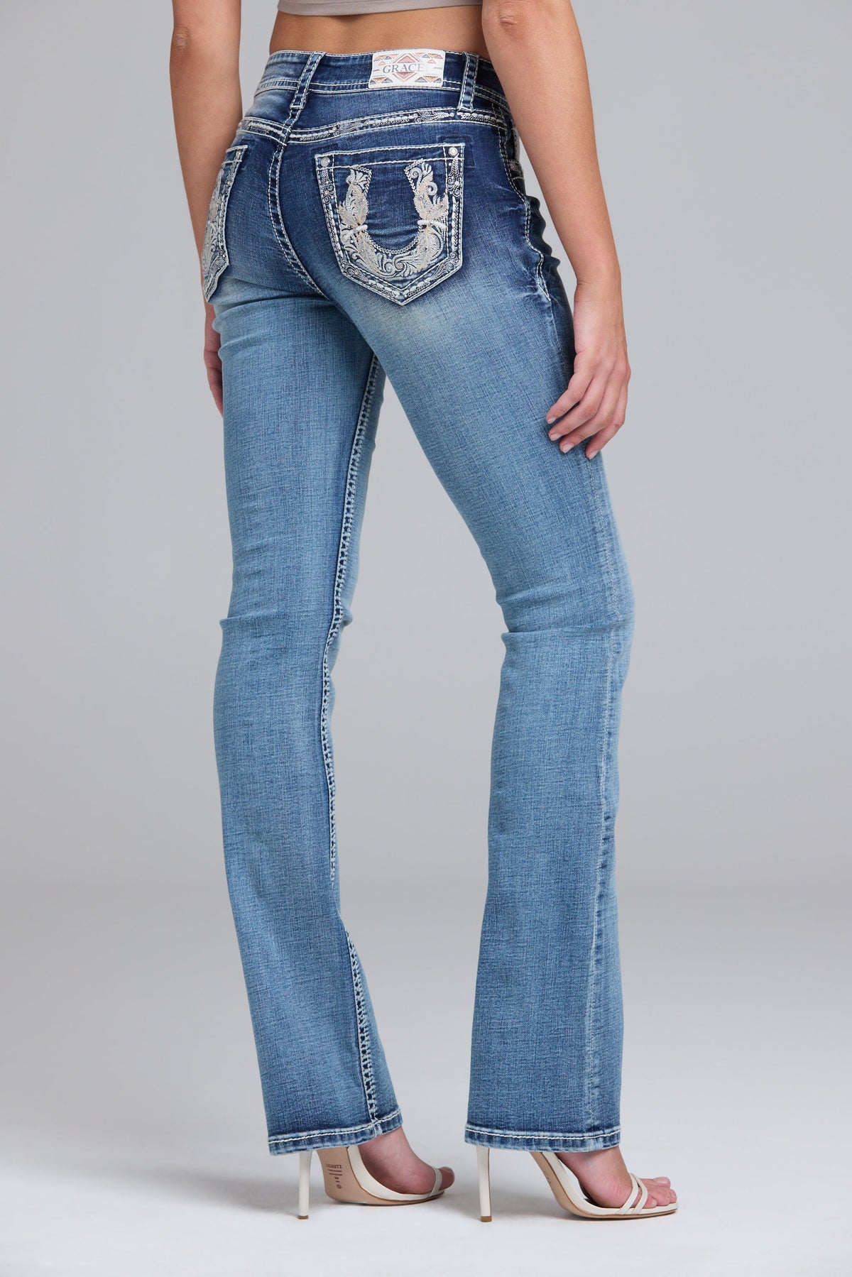 Product view 1 of blue bootcut jeans with horse shoe stitching